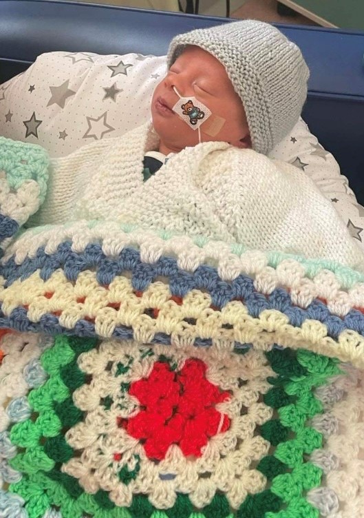 Picture: Henry Longden, eight day- old modelling the knitwear on the Neonatal Unit.