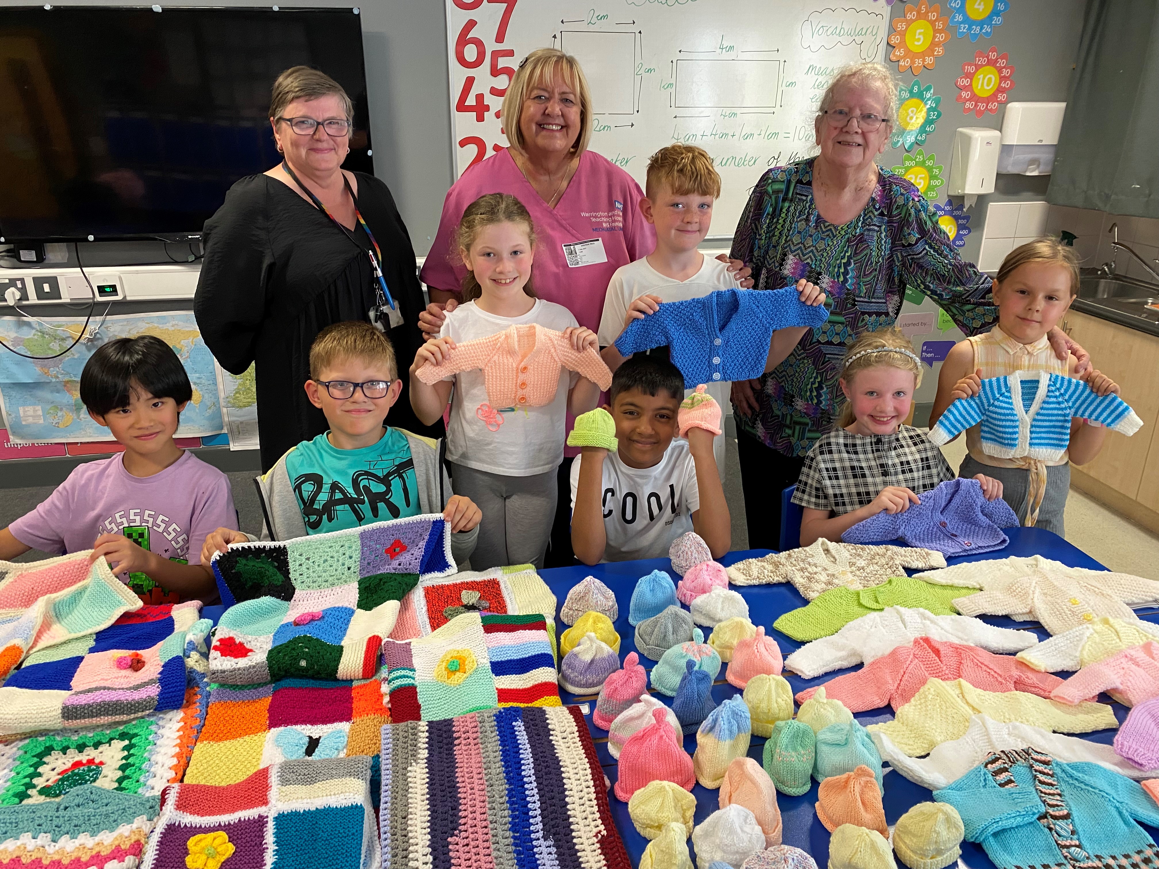 Laura Wright, teacher, Julia Austin, neonatal unit nursery nurse and volunteer Jean Hinchliffe with some of the children from the after-school knitting club.