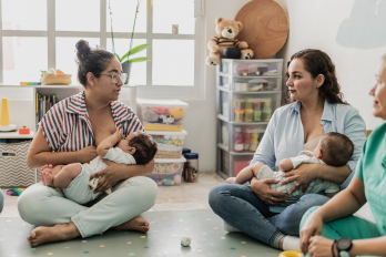 Mother breastfeeding their babies