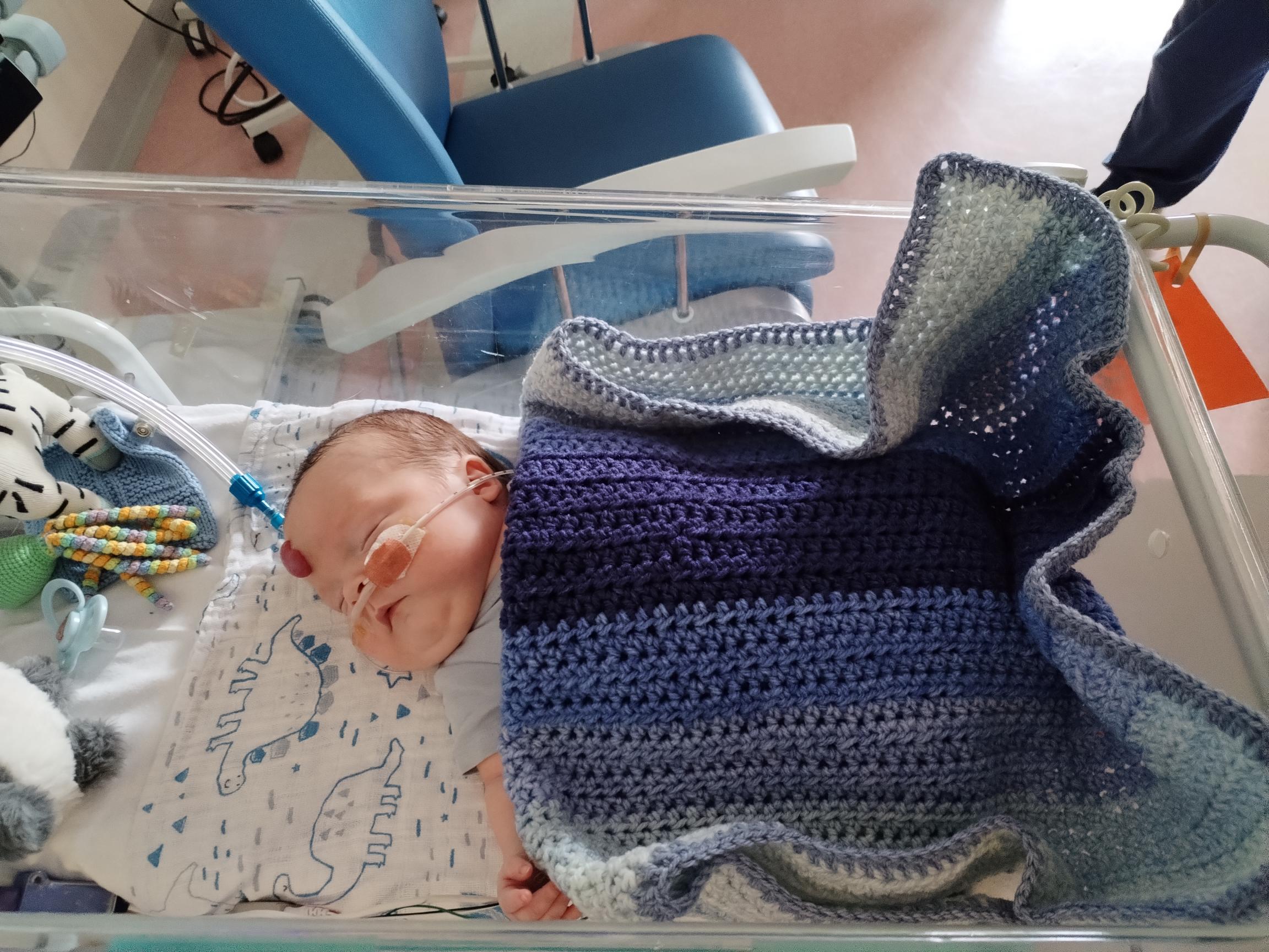 Zachary Blakeley, modelling the knitwear on the Neonatal Unit.