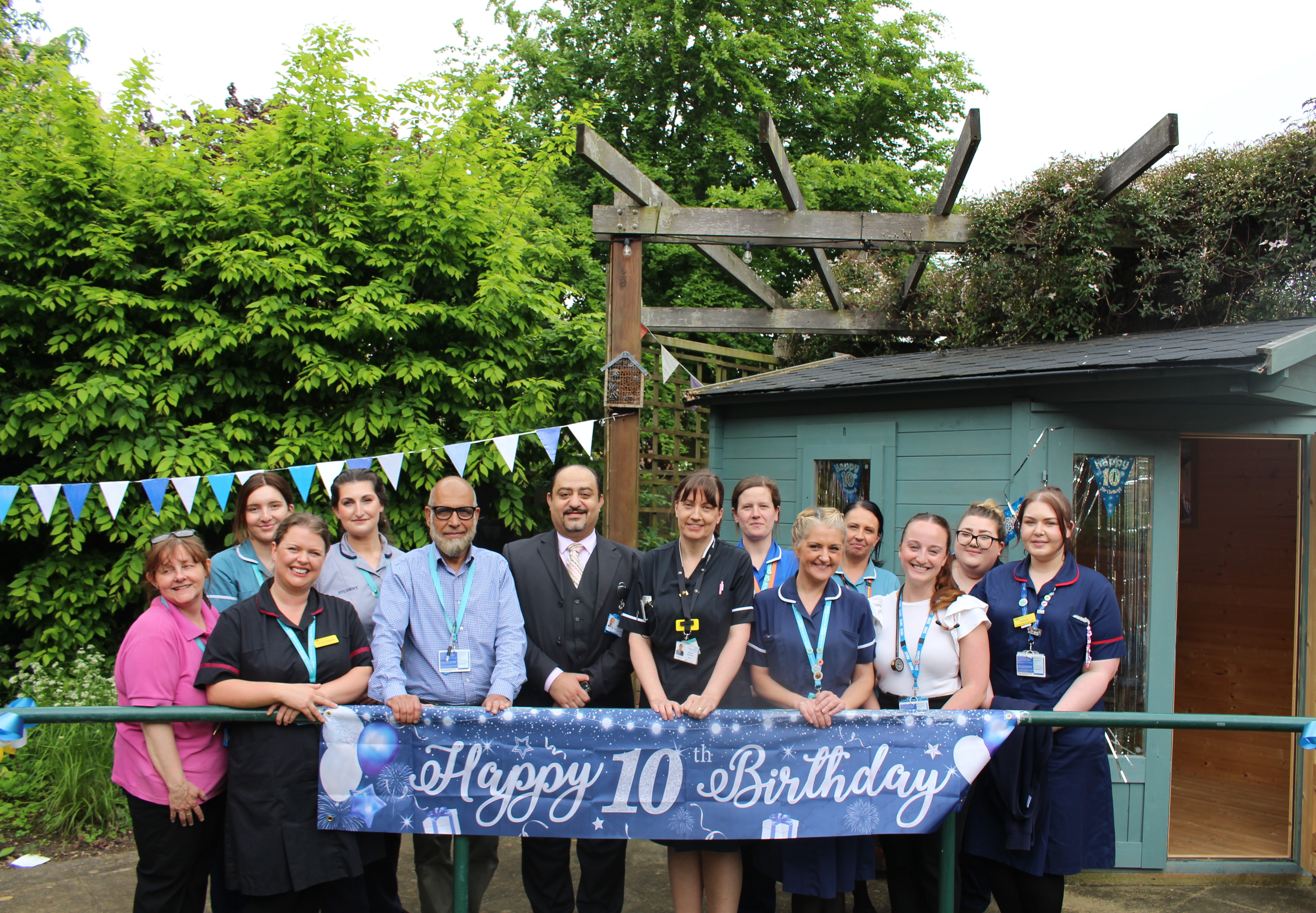 Ward staff celebrate 10-year anniversary in the Forget Me Not Garden.