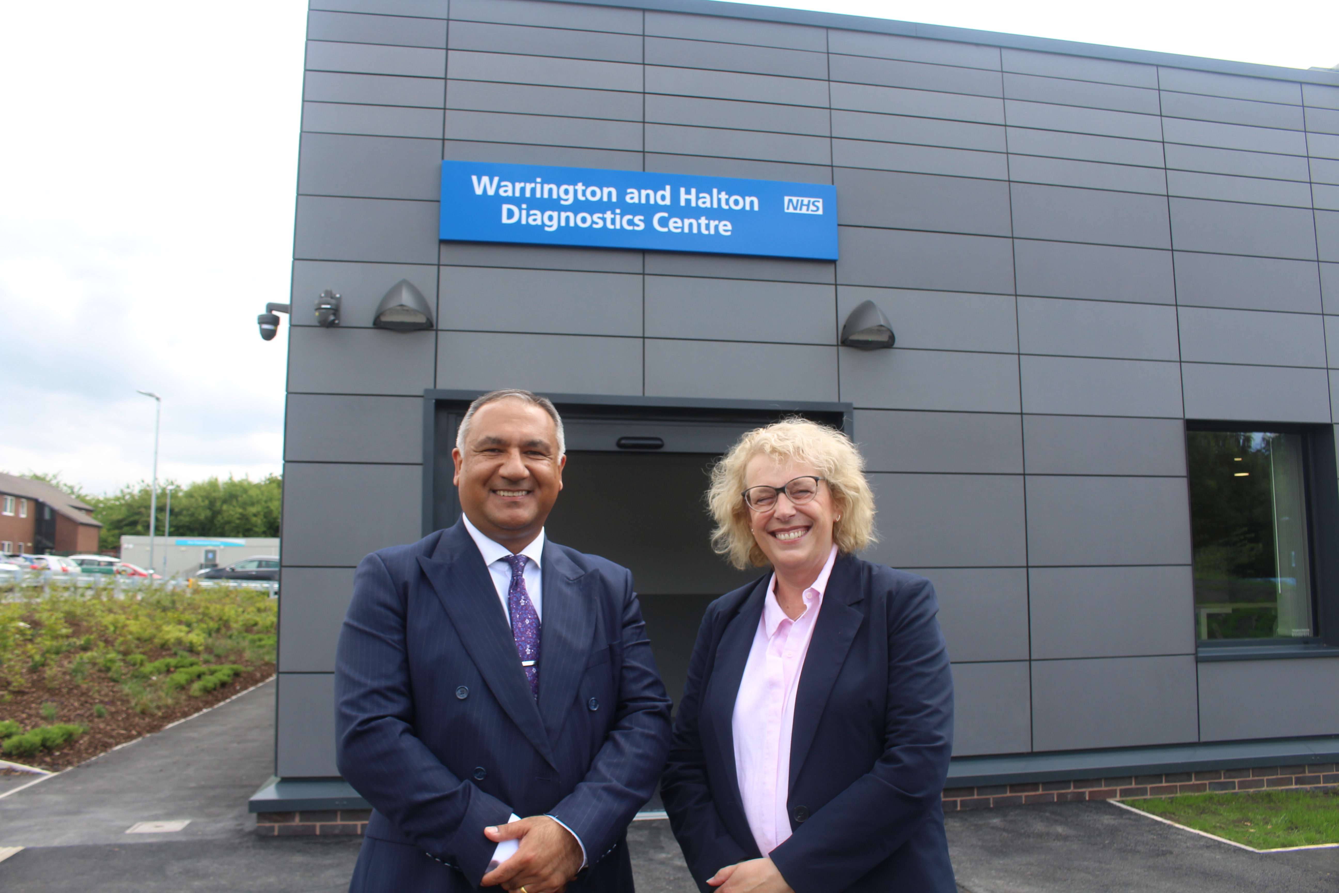 3.	Nikhil Khashu, WHH Chief Executive, and Louise Shepherd CBE, North West Regional Director for NHS England, outside the new centre 