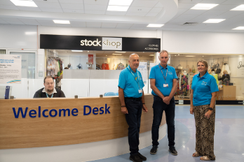 Volunteers stood at Warrington Hospital's welcome desk for patients / service users.