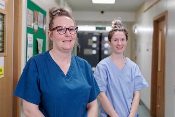 Image of two staff smiling