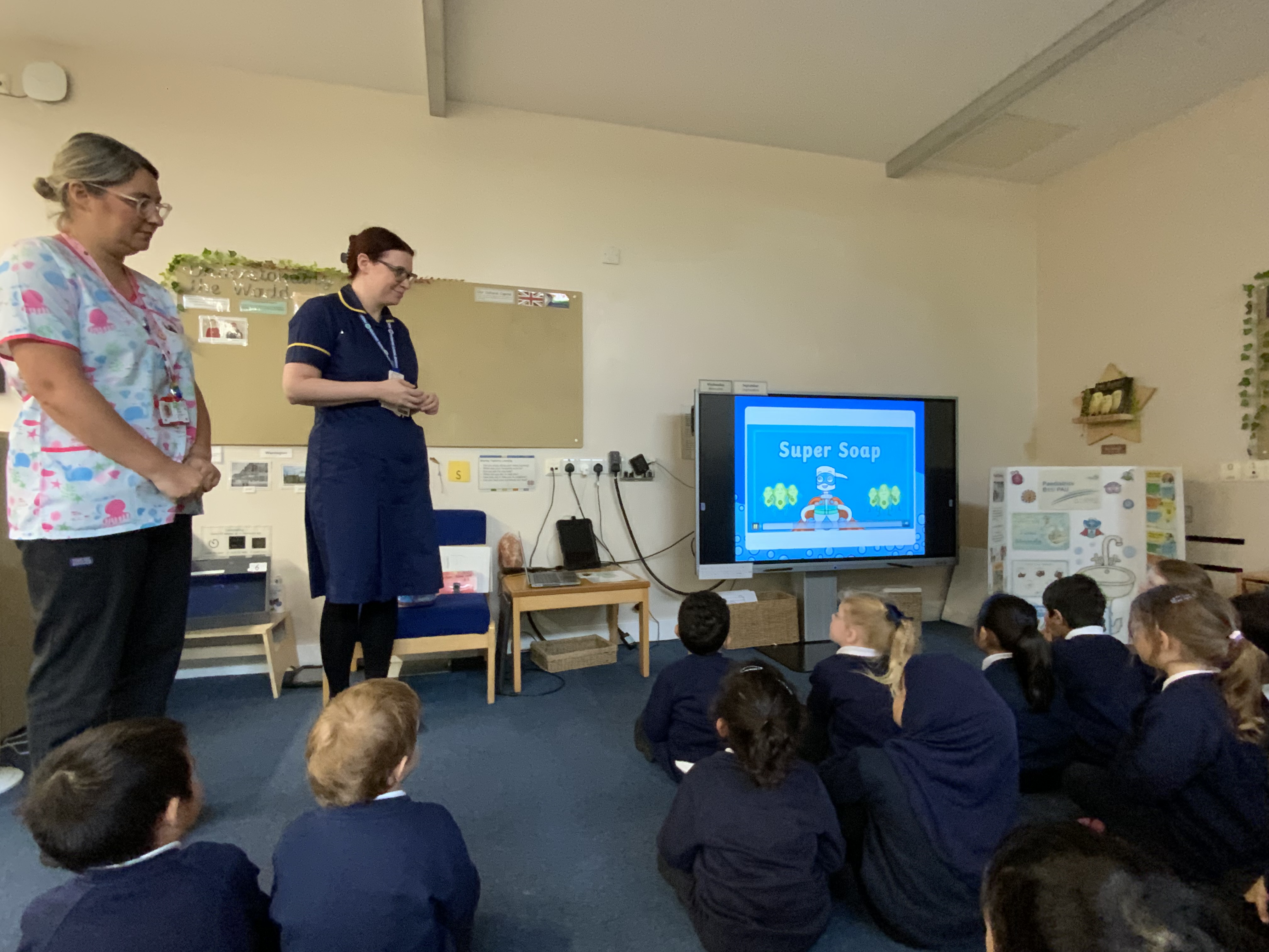 Staff presenting in a classroom with primary school children