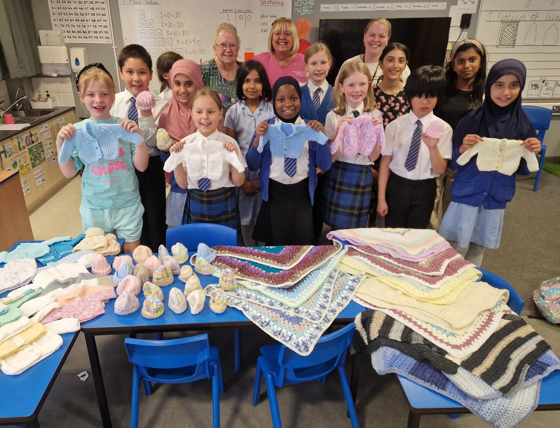 Julia Austin, Neonatal Unit Nursery Nurse with volunteer Jean Hinchliffe and children from the after-school knitting club at Bewsey Lodge Primary School.